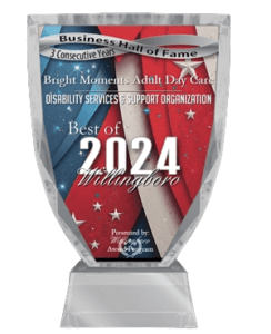 A crystal award with an American flag design, reading: "Business Hall of Fame, 3 Consecutive Years. Bright Moments Adult Day Care. Disability Services & Support Organization. Best of 2024 Willingboro." Presented by Willingboro Award Program.